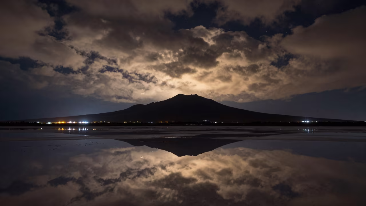 Night Sky Reflected in Flooded Congo Salt Flat in from a quiet alpine saddle in Congo