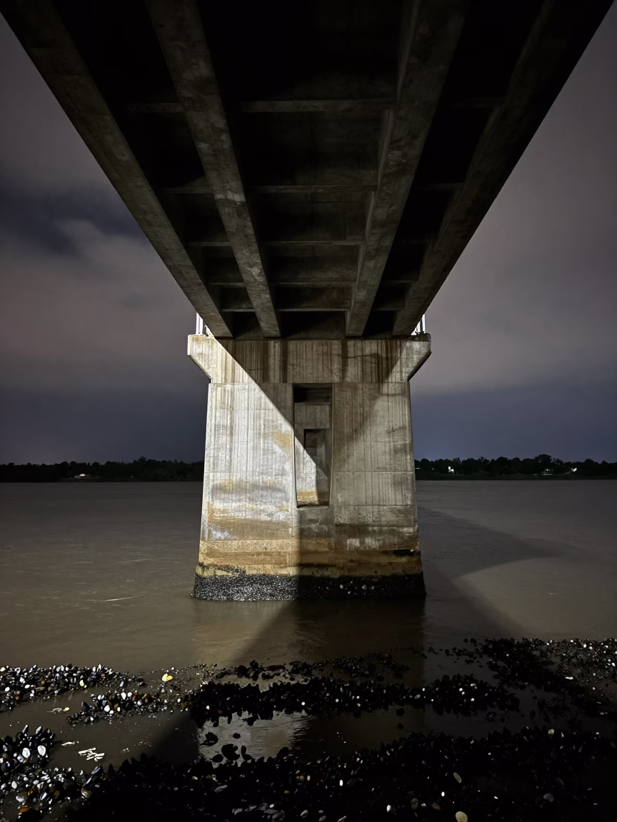 Night Tide Lines on Congo Bridge Pier in under a viaduct of steel and concrete in Congo