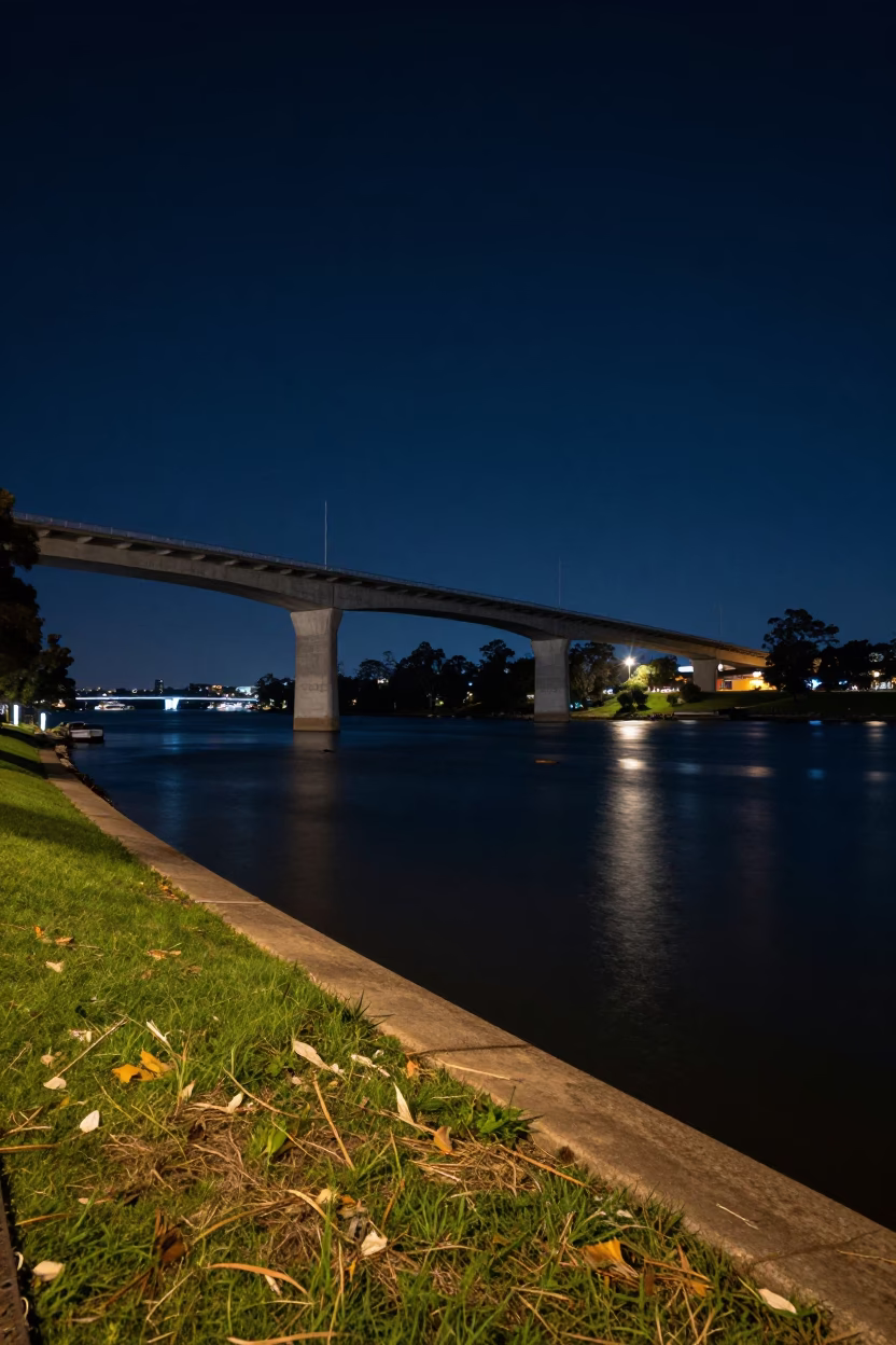 Nighttime Adelaide Riverbank Scene with Concrete Viaduct and Water Ripples in in Adelaide, South Australia, Australia