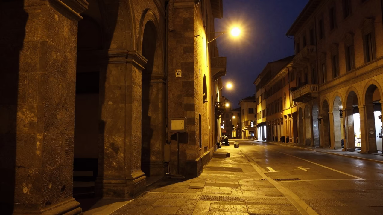 Nighttime Bologna Street Corner with Stone Architecture and City Lights in in Bologna, Italy