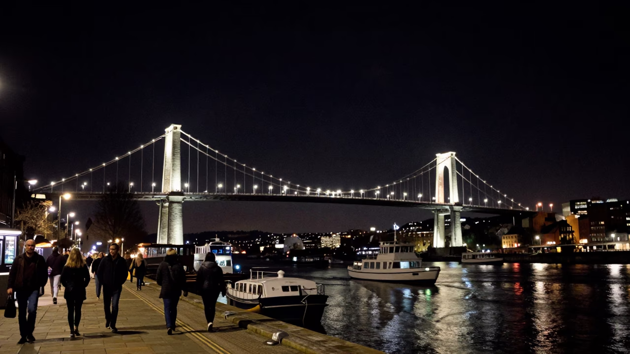 Nighttime Bristol Harbour View with Clifton Suspension Bridge Illuminated Against Dark Sky in in Bristol, United Kingdom