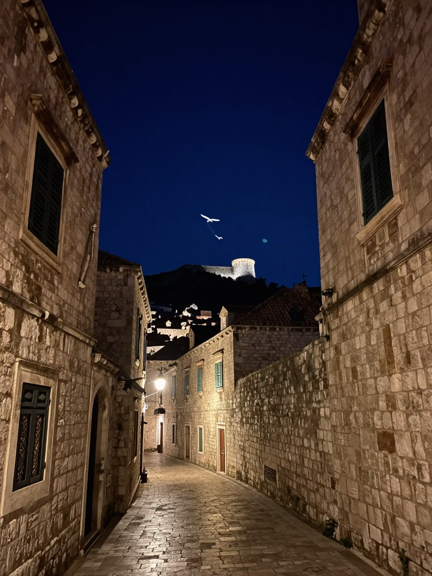 Nighttime Dubrovnik Street Scene with Glider Silhouette and Window Light on Handle in in Dubrovnik, Croatia