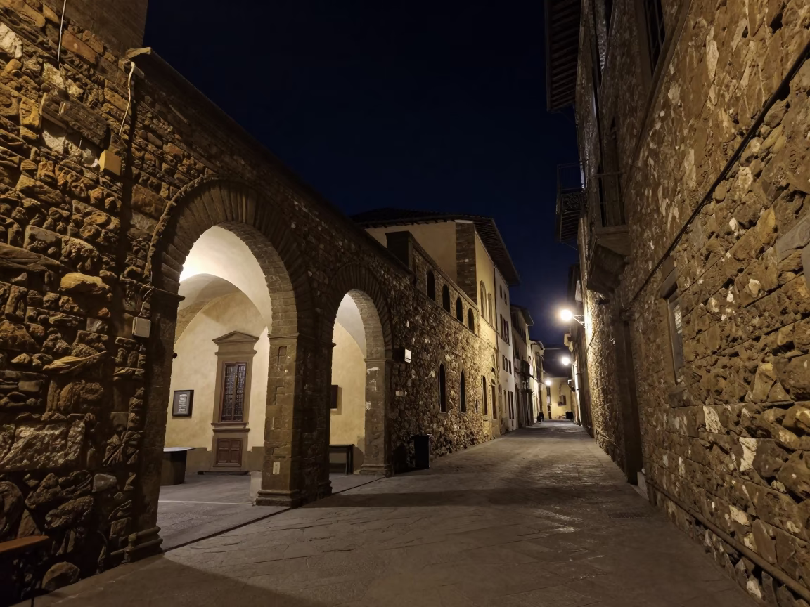 Nighttime Florence Street Scene with Stone Archways and Dimly Lit Cafe Exterior in in Florence, Italy