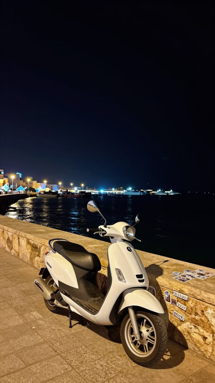 Nighttime Harbor Promenade in Casablanca Morocco with Parked Scooter and Postcards in in Casablanca, Morocco