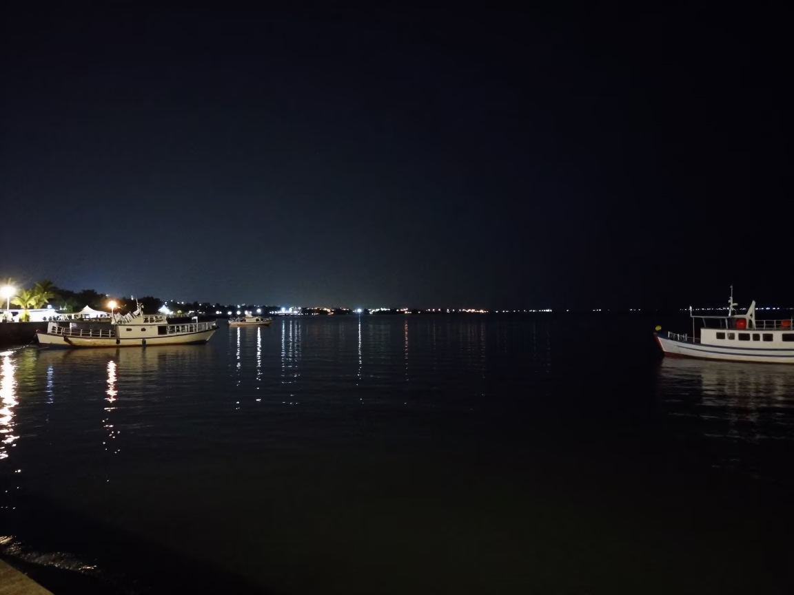 Nighttime Harbor Scene in Kochi India with Boat and Water Reflections in in Kochi, India