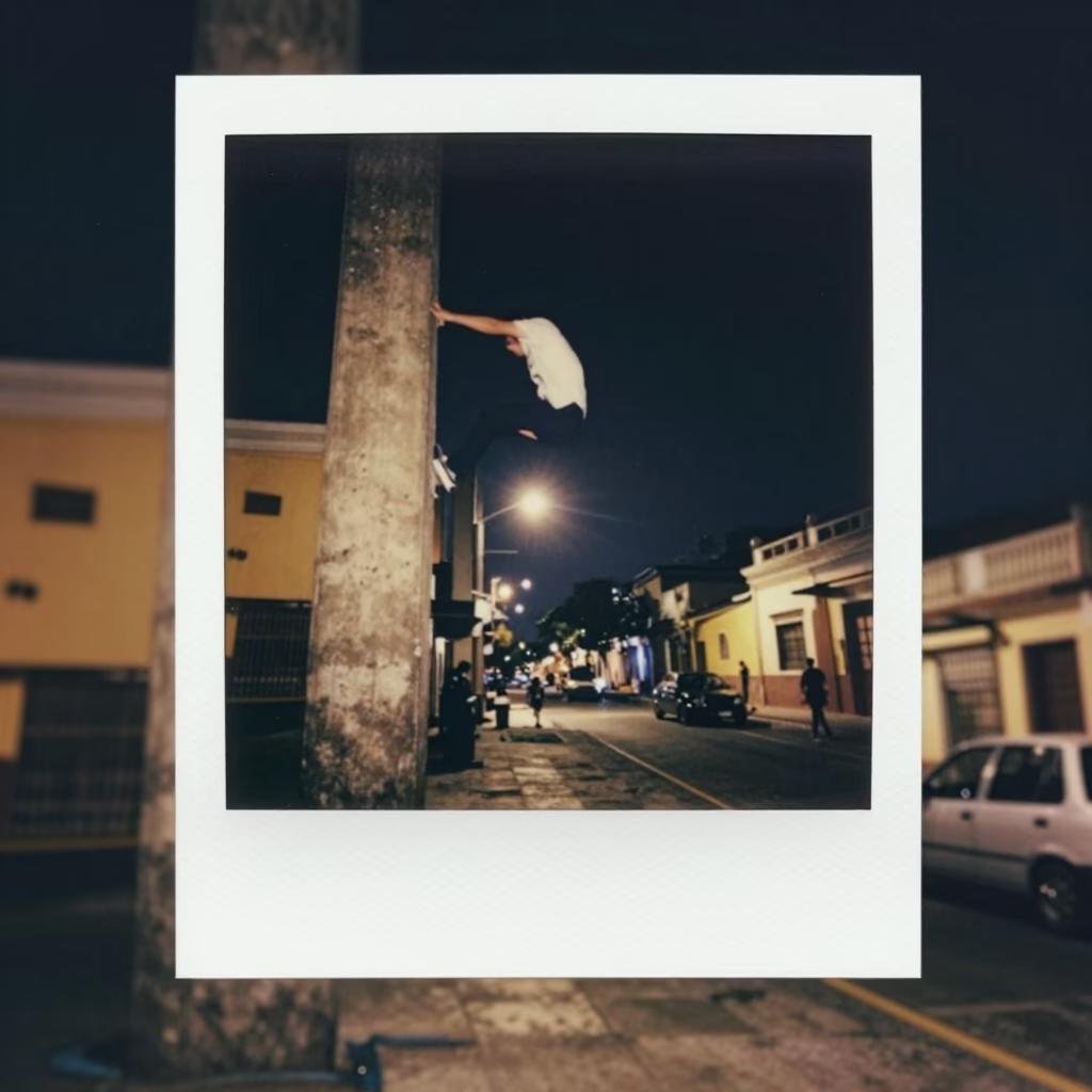 Nighttime Lima Street Scene with Parkour Athlete Running on Concrete Pillar Under Deep Sky in in Lima, Peru