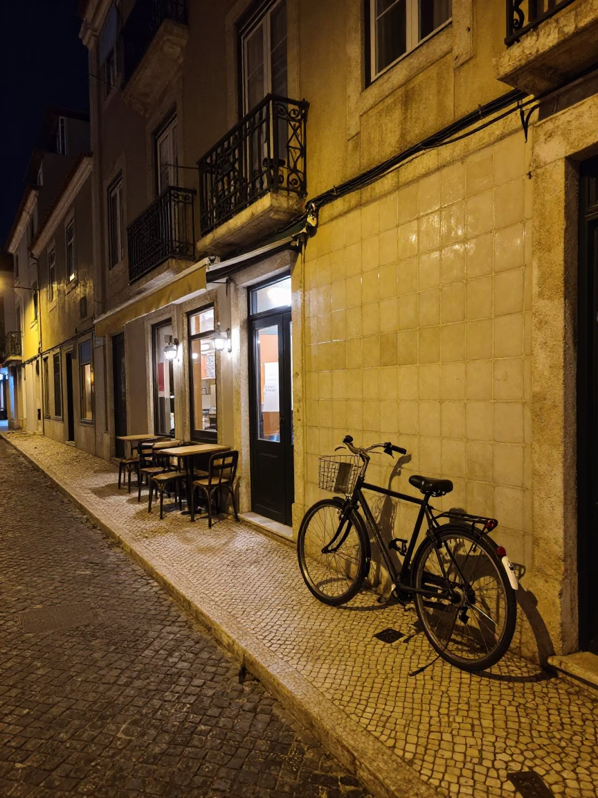 Nighttime Lisbon Street Scene with Bicycle and Cafe Atmosphere in in Lisbon, Portugal