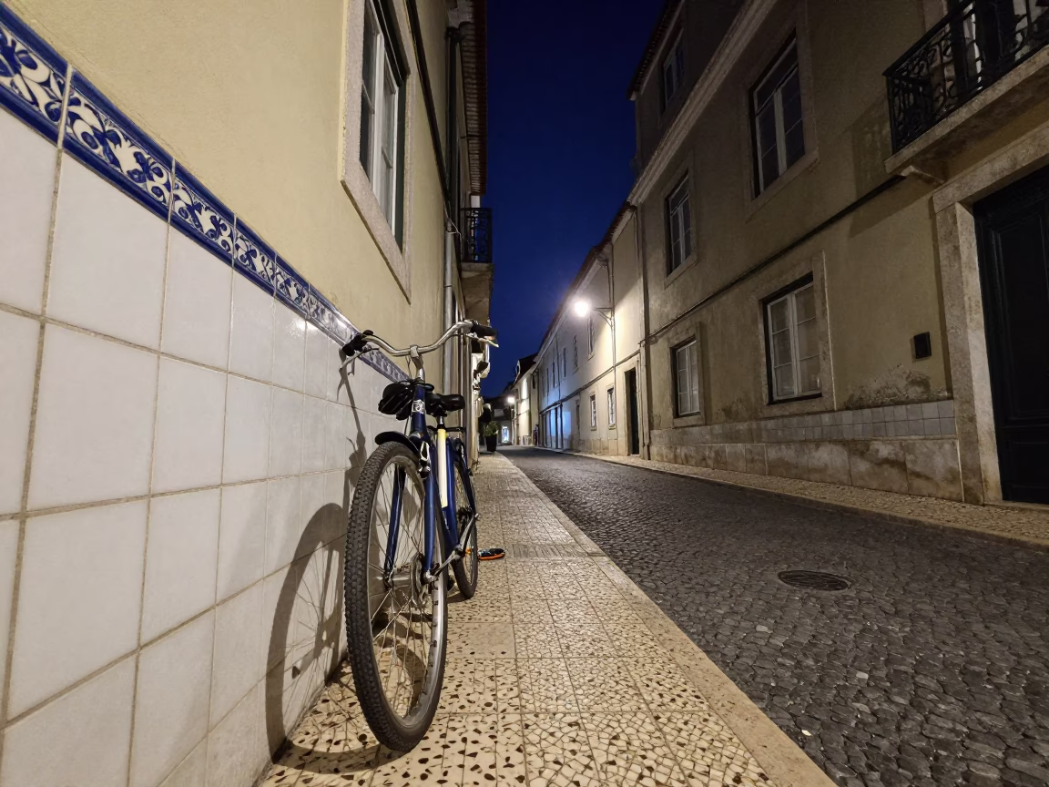 Nighttime Lisbon Street Scene with Ceramic Tiles and Bicycle Under Deep Sky in in Lisbon, Portugal