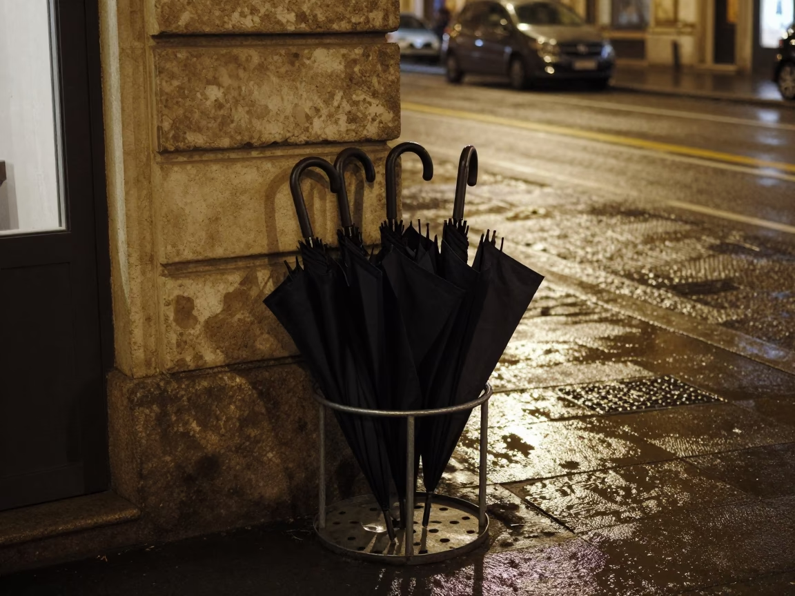 Nighttime Milan street scene with umbrella stand and mineral rings on window glass in in Milan, Italy