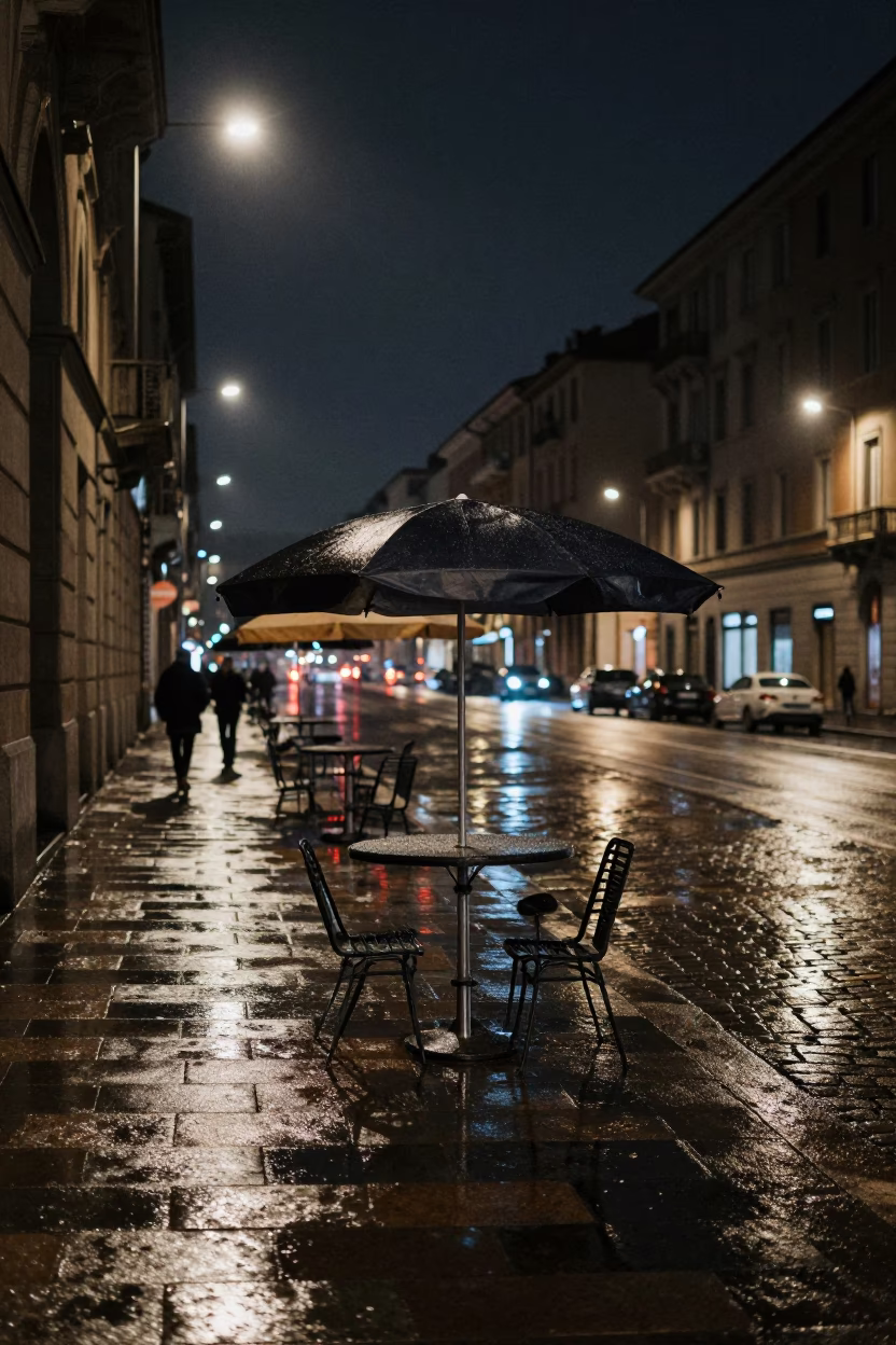 Nighttime Milan Street Scene with Umbrella Stand and Wet Cobblestones in in Milan, Italy
