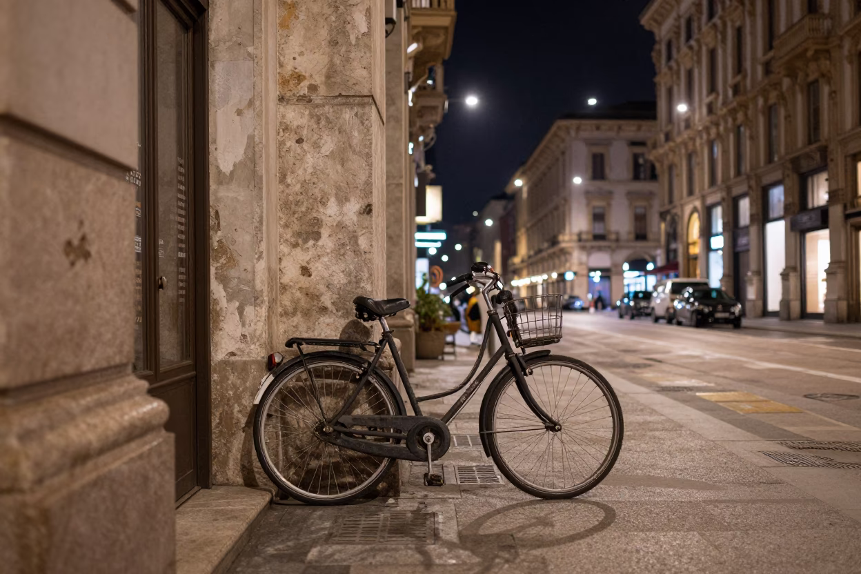 Nighttime Milan Street Scene with Vintage Bicycle and Neon Shop Signage in in Milan, Italy