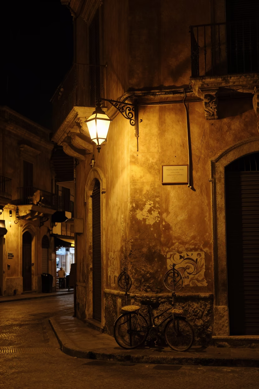 Nighttime Palermo Street Corner with Hanging Lanterns and Dimly Lit Cafe Interior in in Palermo, Italy