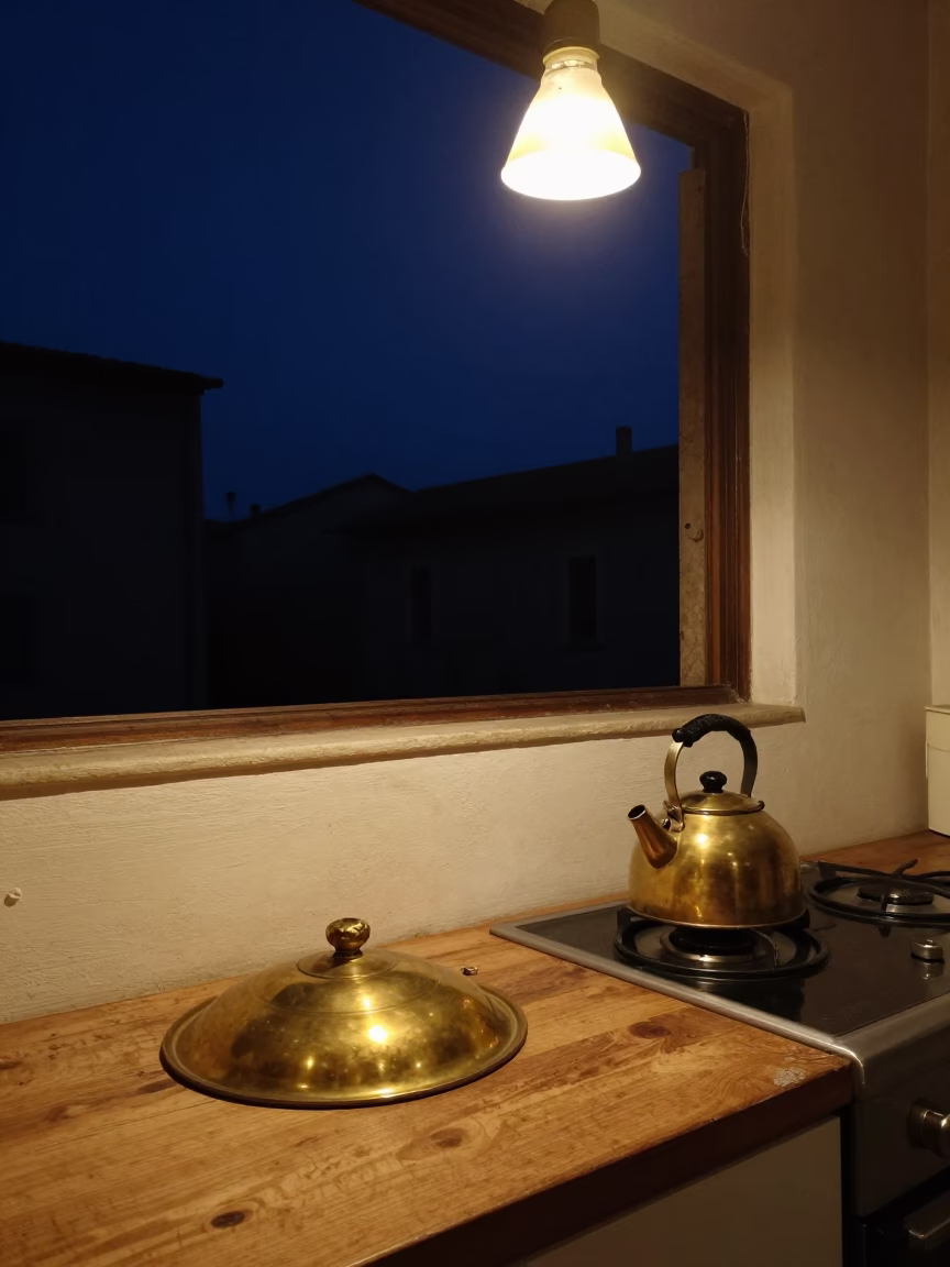 Nighttime Roman Kitchen Interior with Brass Pot Lid and Stovetop Kettle Under Deep Sky in in Rome, Italy