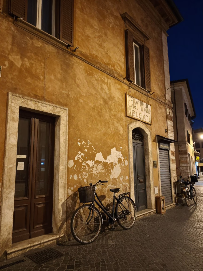 Nighttime Rome Italy street scene with bicycle leaning against cafe wall under deep sky in in Rome, Italy