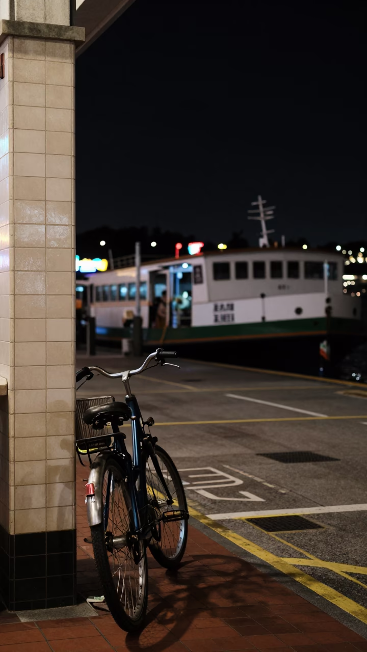 Nighttime Singapore Street Scene with Bicycle and Ferry Dock Activity in in Singapore, Singapore