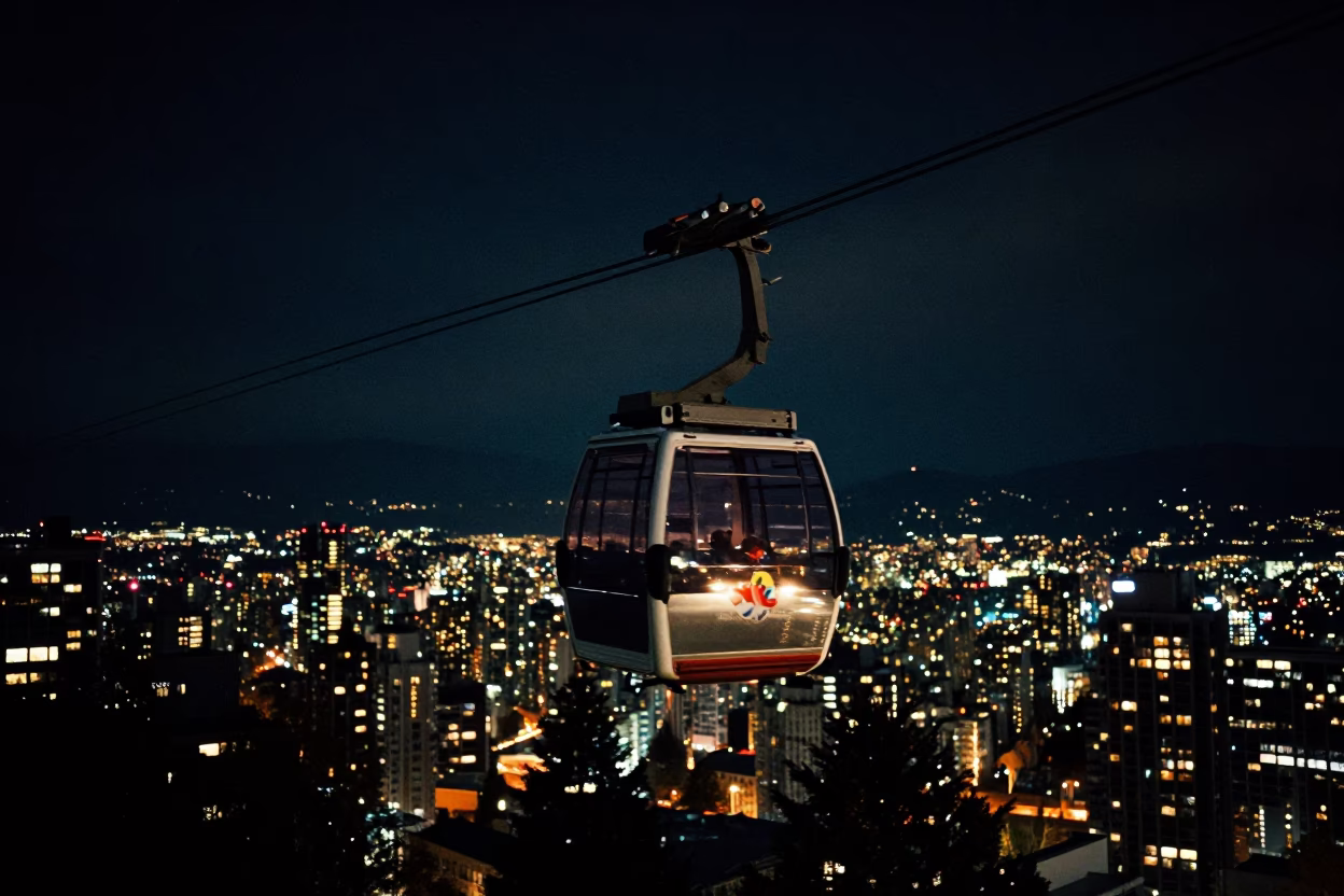 Nighttime SkyTrain Cable Car Glint Over Vancouver British Columbia City Lights in in Vancouver, British Columbia, Canada