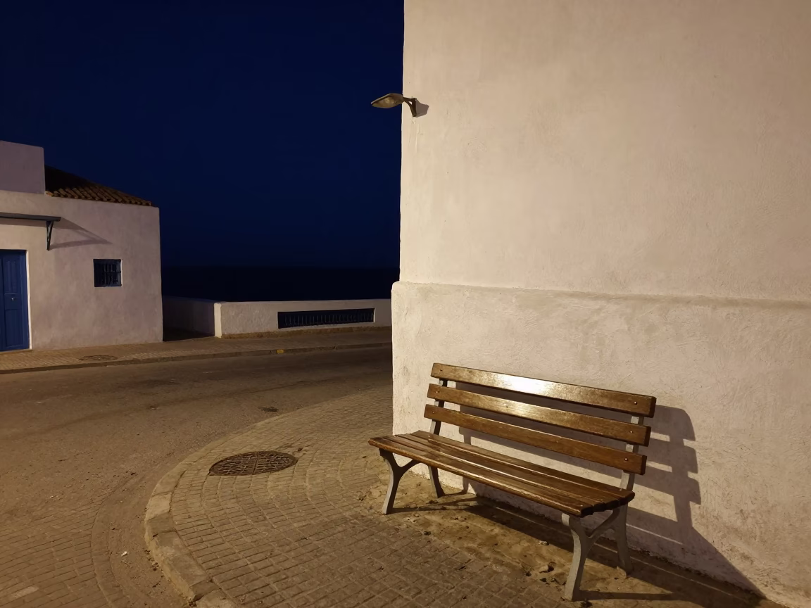 Nighttime Street Scene in Essaouira Morocco with Wooden Bench and Sea Fog in in Essaouira, Morocco