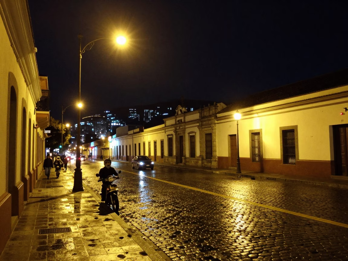 Nighttime Street Scene in Quito Ecuador with Motorcycle and City Lights in in Quito, Ecuador