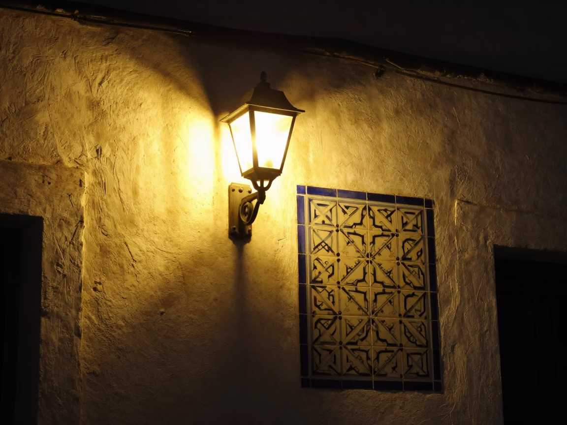 Nighttime street scene in Tunis Tunisia with wall sconce and patterned fish scales in in Tunis, Tunisia