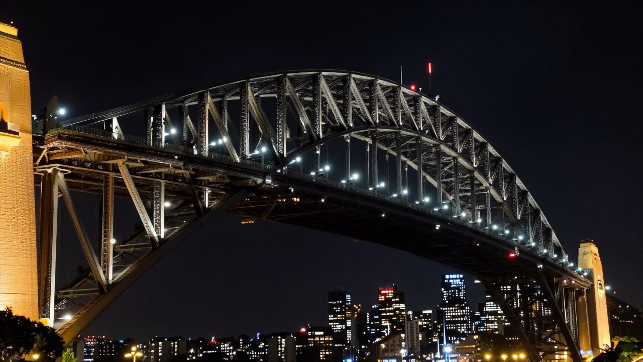 Nighttime Sydney Harbour Bridge steel trusses and urban city lights in in Sydney, New South Wales, Australia