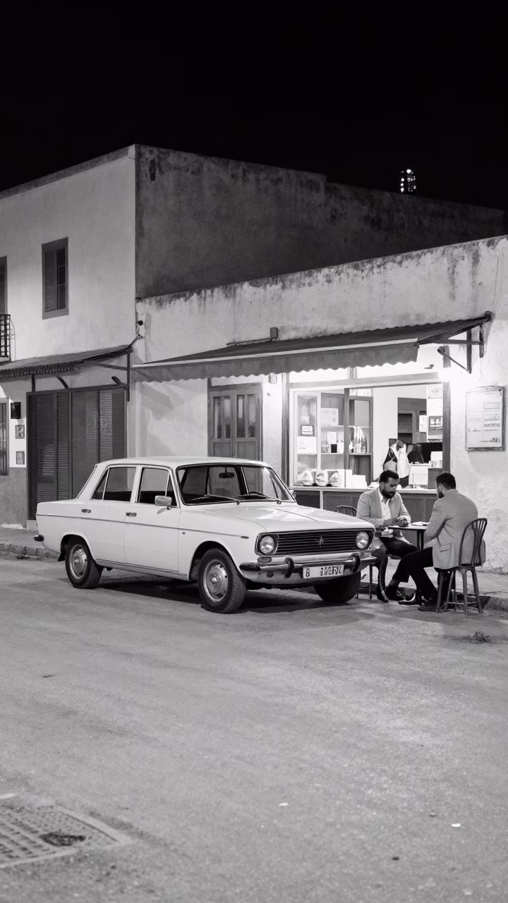 Nighttime Tunis Street Scene with Vintage Car and Local Diners in in Tunis, Tunisia