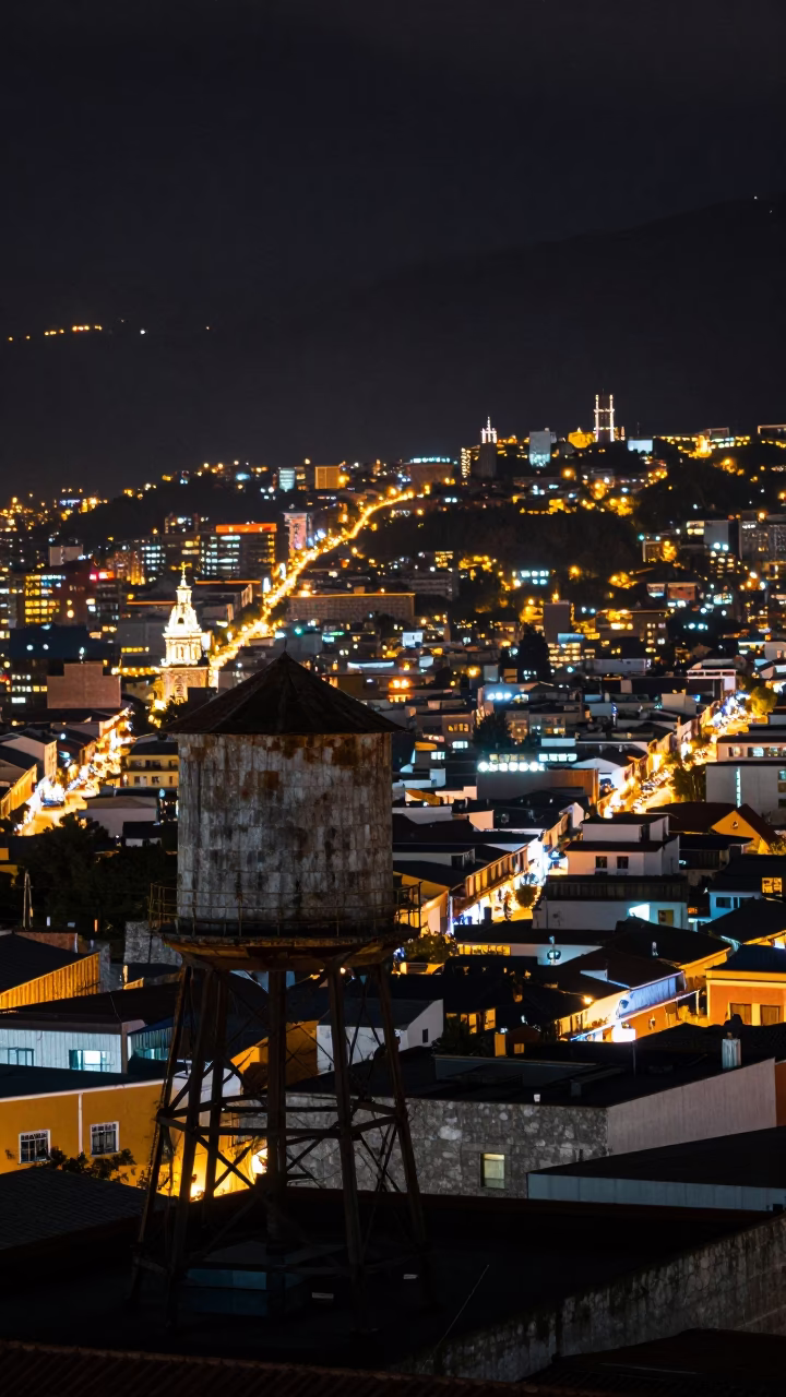 Nighttime Urban Landscape of Quito Ecuador with Water Tower and City Lights in in Quito, Ecuador