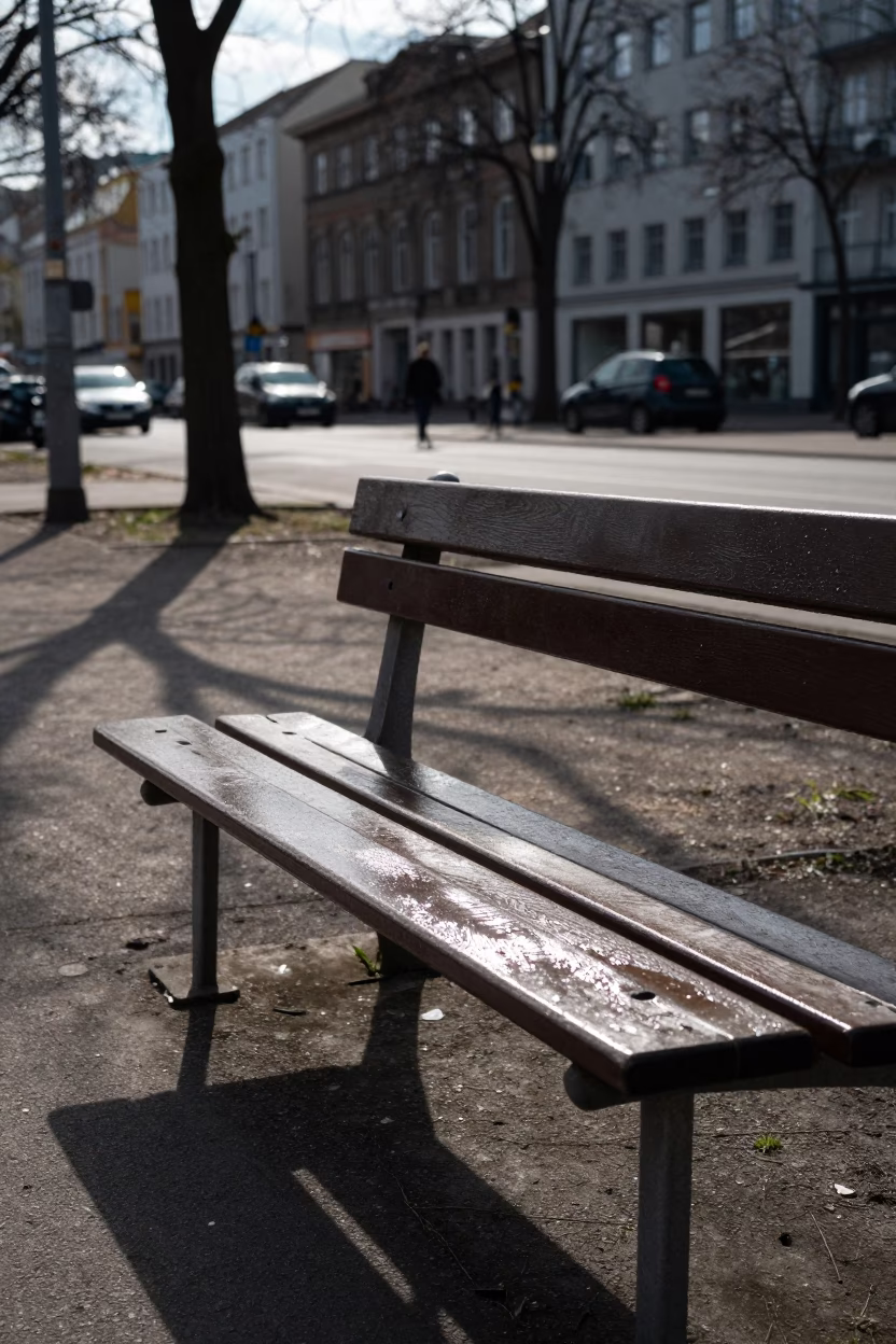 Noon Light on Berlin Park Bench Showing Grease Sheen and Urban Street Life in in Berlin, Germany