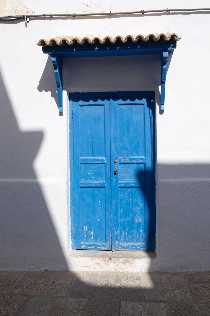 Noon Light on Blue Shuttered Alleyway with Metal Bucket in Essaouira Morocco in in Essaouira, Morocco