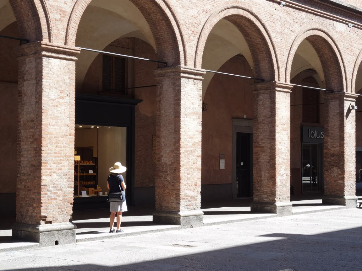 Noon light on Bologna porticoes capturing street life and local details in in Bologna, Italy