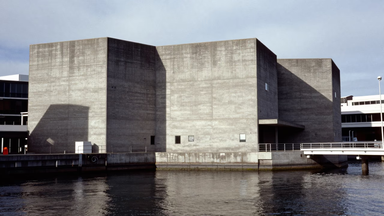 Noon light on Hobart waterfront concrete brutalist architecture and harbor water reflections in in Hobart, Tasmania, Australia