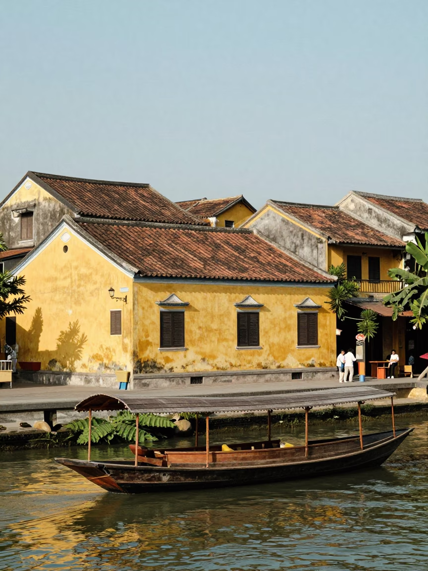 Noon light on Hoi An ancient town yellow walls and river traffic in in Hoi An, Vietnam