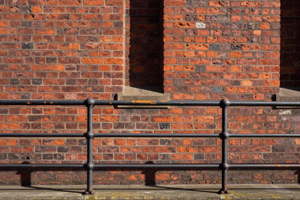 Noon Light on Liverpool Docklands Brickwork and Weathered Metal Railings in in Liverpool, United Kingdom