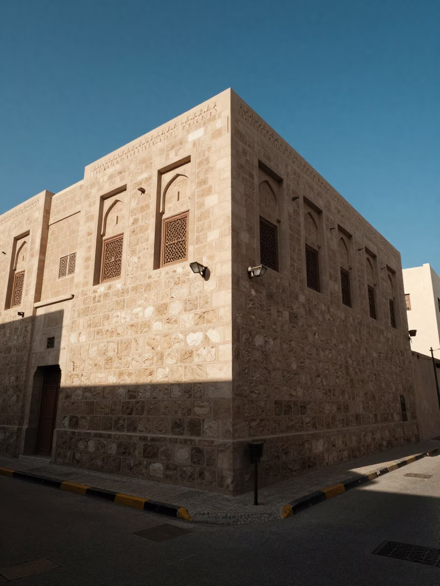 Noon Light on Muscat Street Corner with Stone Walls and Local Commerce in in Muscat, Oman