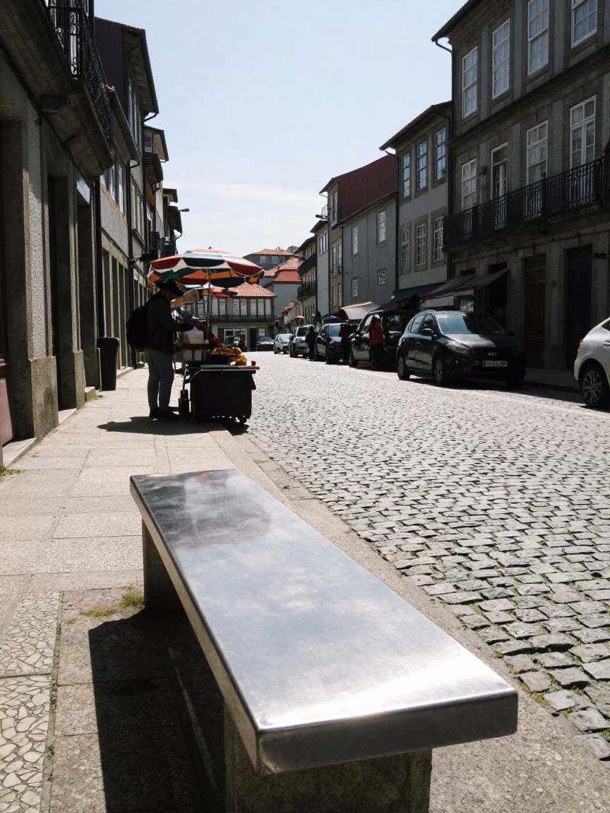 Noon Light on Porto Cobblestones with Street Vendor and Brushed Steel Bench in in Porto, Portugal