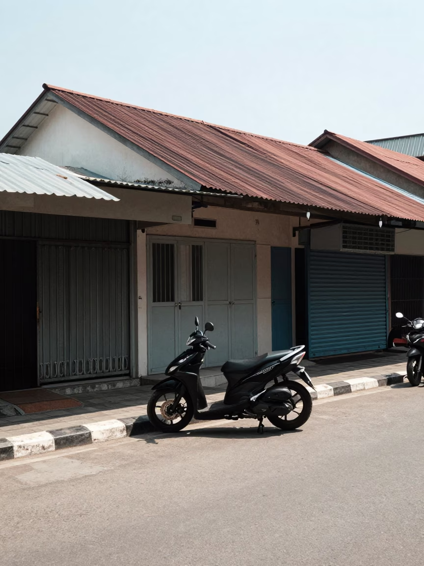 Noon Light on Yogyakarta Street with Parked Scooter and Traditional Shopfront in in Yogyakarta, Indonesia