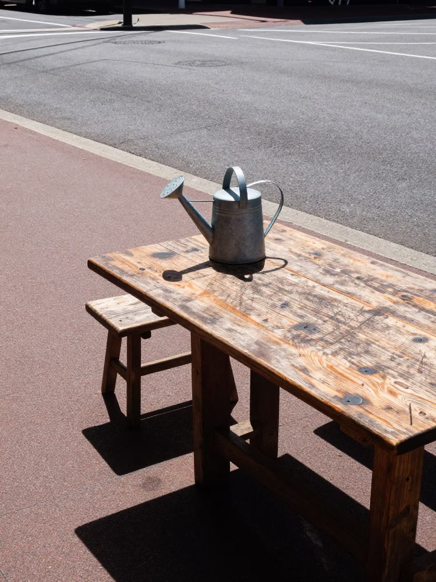 Noon Sunlight on Adelaide Street Corner with Watering Jug and Scratched Table in in Adelaide, South Australia, Australia
