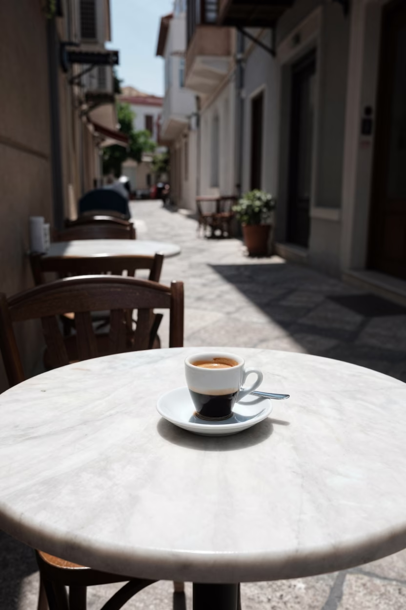 Noon Sunlight on Athens Cafe Table With Espresso Cup And Saucer in in Athens, Greece