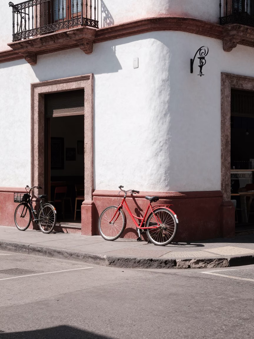 Noon Sunlight on Guadalajara Street Corner with Bicycle and Window Box Details in in Guadalajara, Mexico