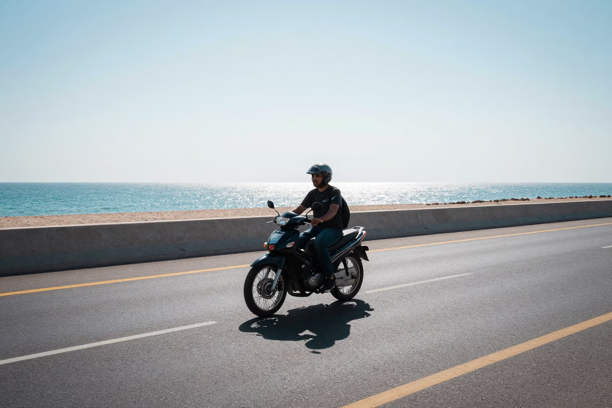 Noon Sunlight on Muscat Coastal Highway with Motorcycle and Local Street Details in in Muscat, Oman