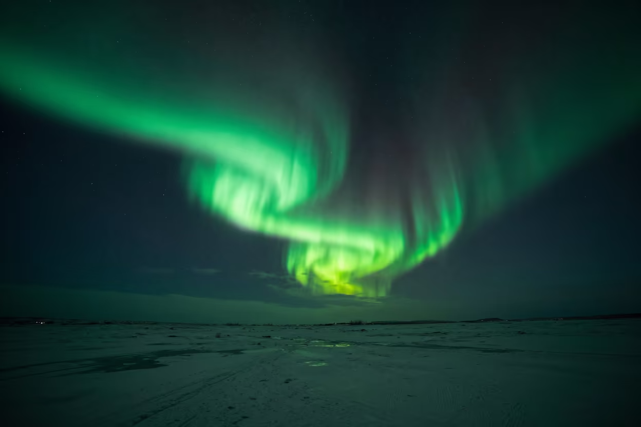 Northern Lights Over Frozen Icelandic Tundra in beneath a dark-sky overlook in Iceland