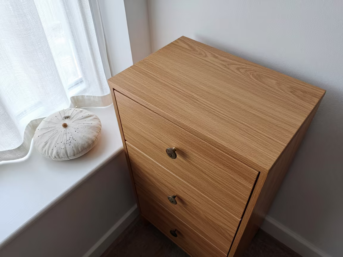 Oak Sewing Cabinet Pincushion Noon Light in on a painted display ledge near Buffalo