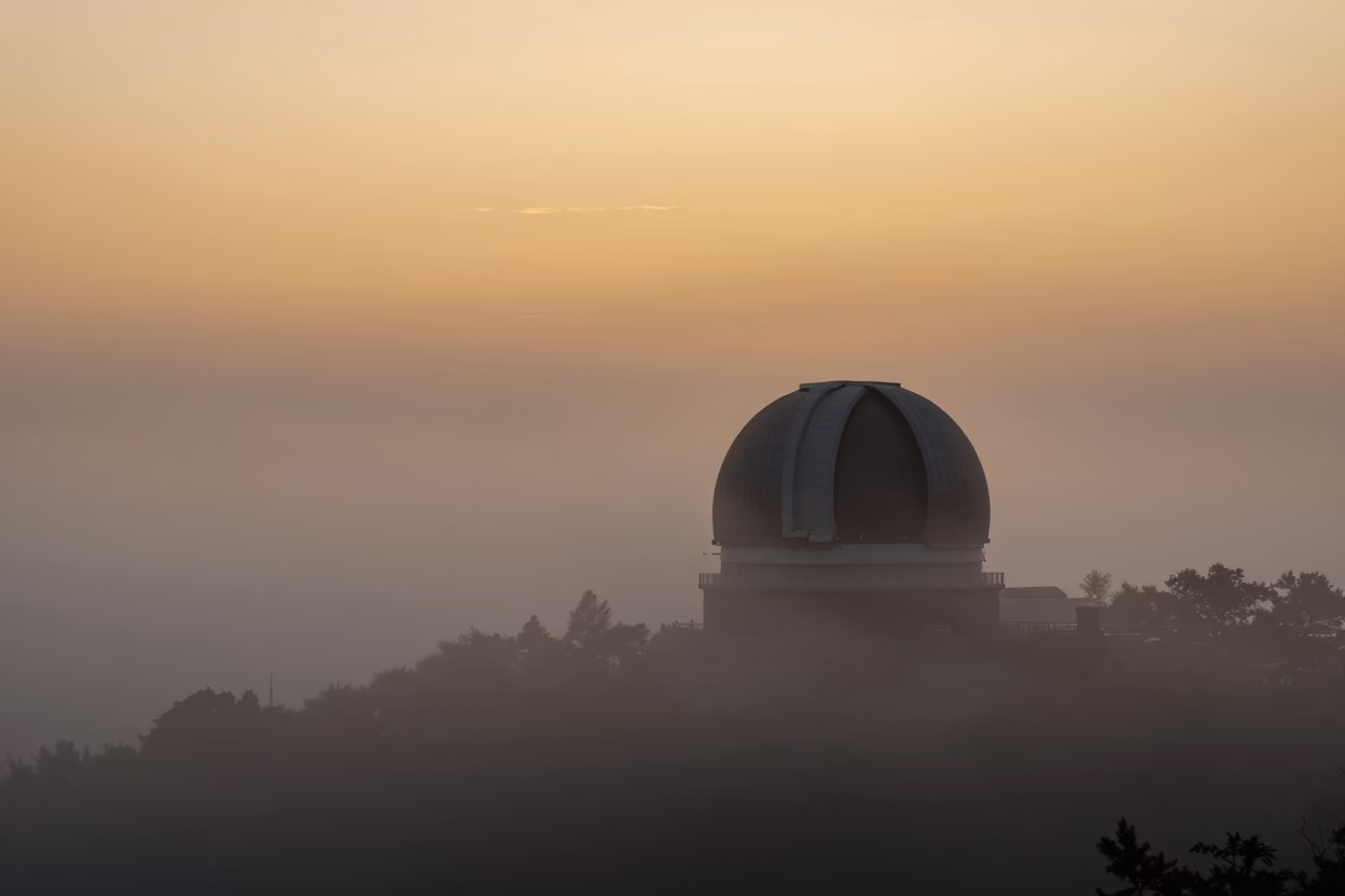 Observatory Dome Silhouette Above Drifting Ground Fog in Beijing in in Beijing, China