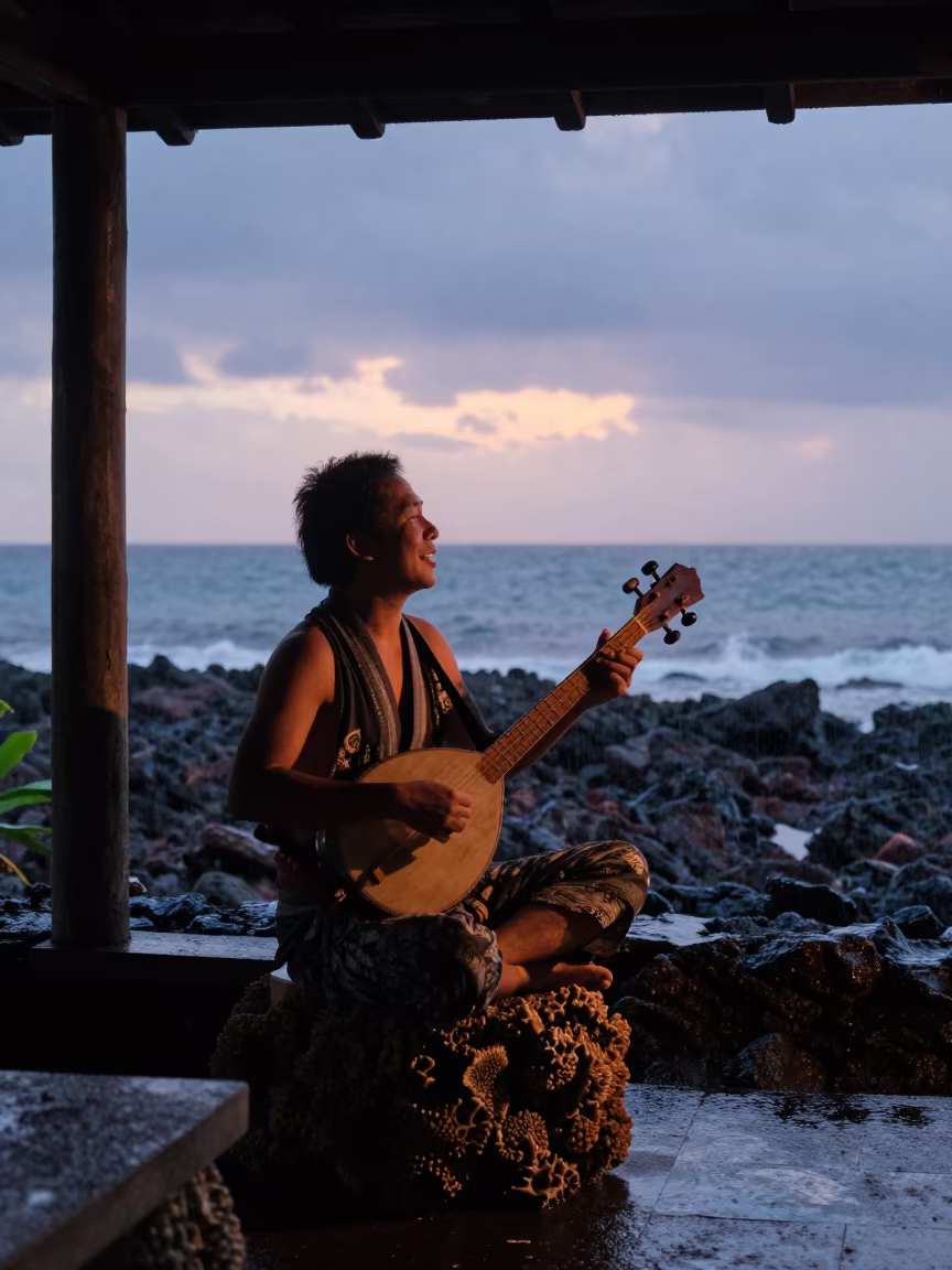 Okinawan Sanshin Player Singing on Coral Porch at Twilight in beside a volcanic reef overhang near Stone Town