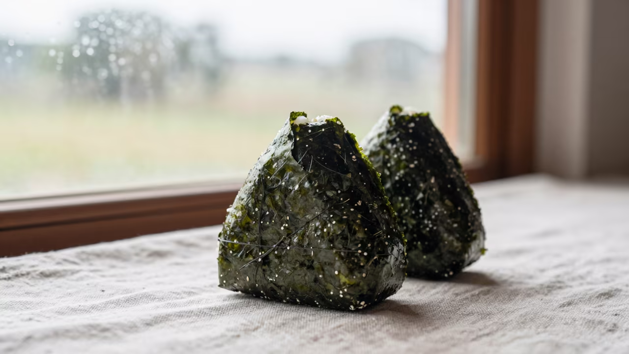 Onigiri Wrapped in Nori on Linen Table in on a linen-covered restaurant table in Masvingo