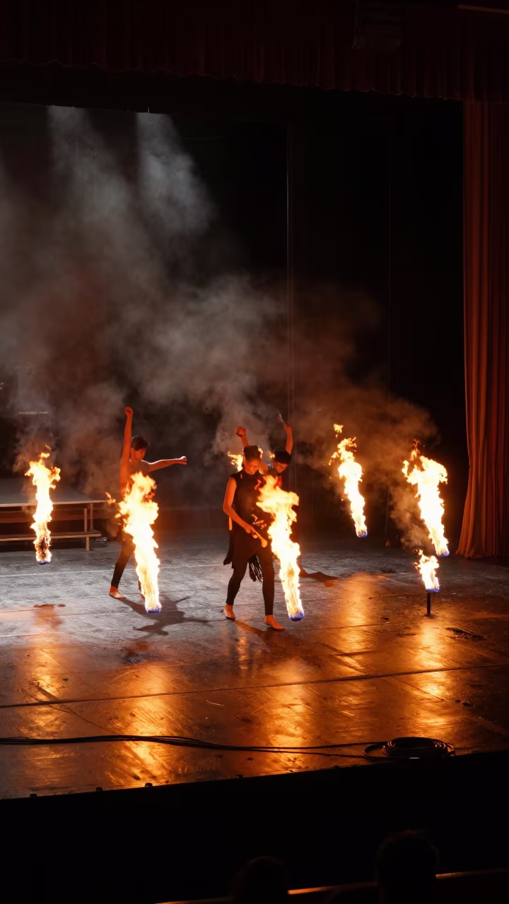 Orange Fire Dance Arcs on Maturín Stage in on a theater stage in Maturín