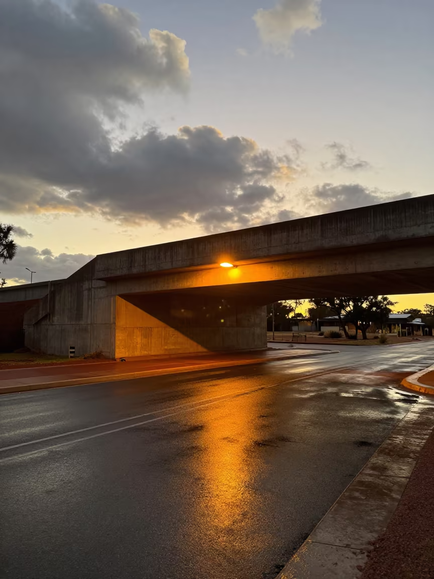 Orange Light on Wet Alice Springs Underpass Pavement in beneath a flickering underpass light in Alice Springs