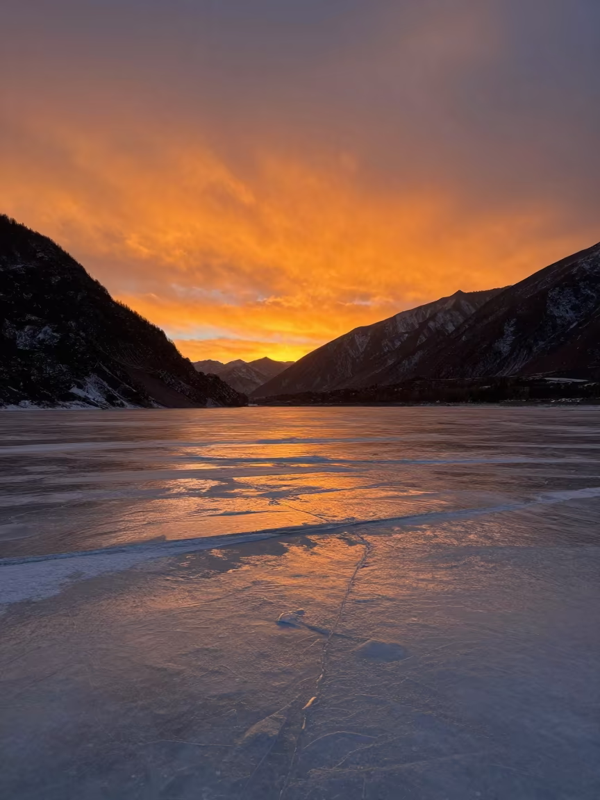Orange Polar Sunset Over Tibet Valley Ice in across a wide valley floor in Tibet