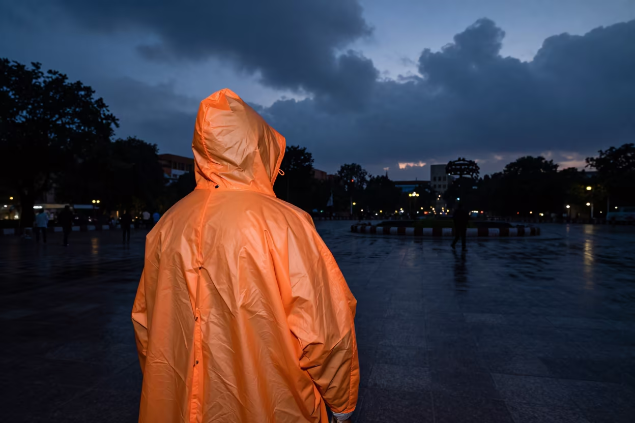 Orange Rain Poncho in Ahmedabad Square in in a public square near Ahmedabad