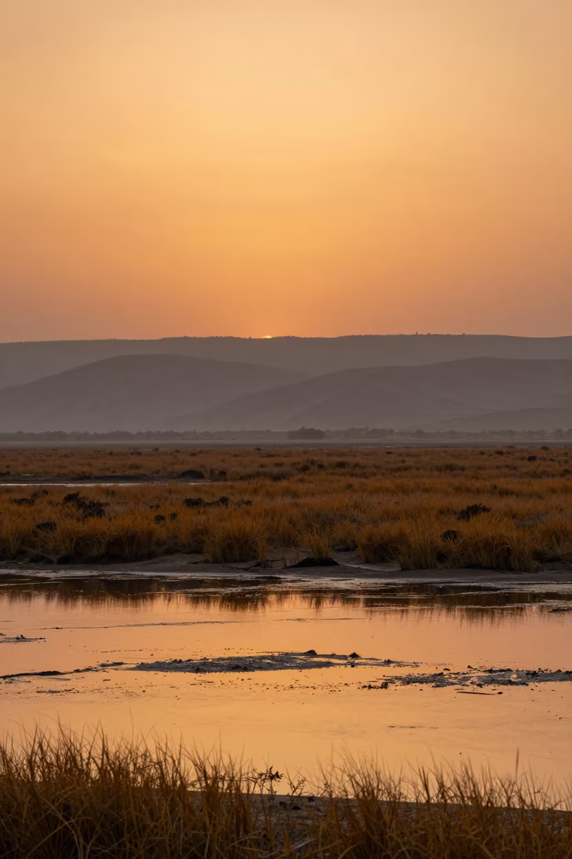 Orange Sunset Over Iraqi Foothills Tidal Flat in from a ridge above layered foothills in Iraq