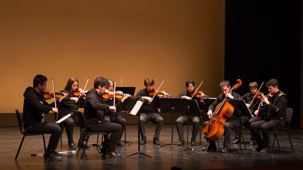 Orchestra Tuning in Amber Sunset Light in on a theater stage in Macarena, Seville